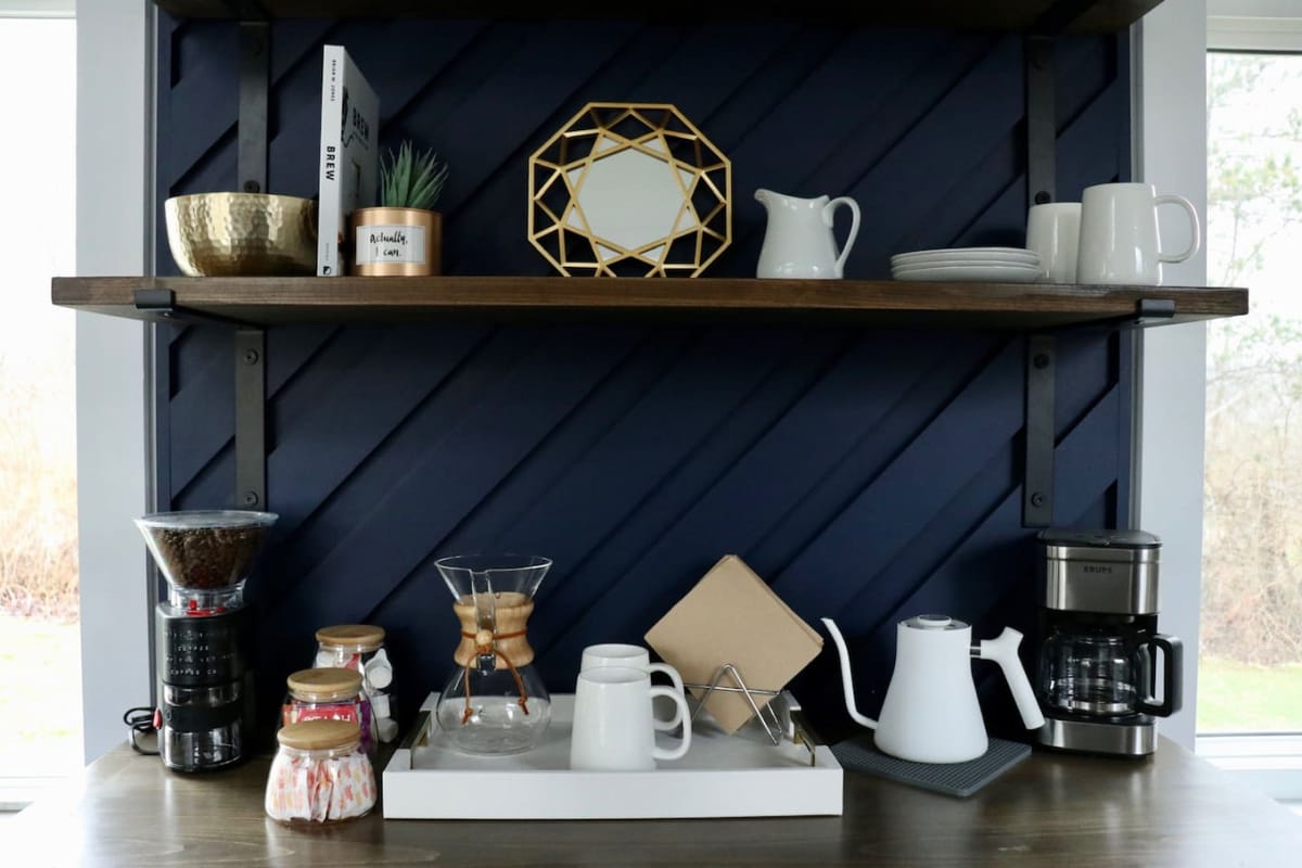 The Lux coffee bar with pour-over, drip maker, and burr grinder on navy shelves