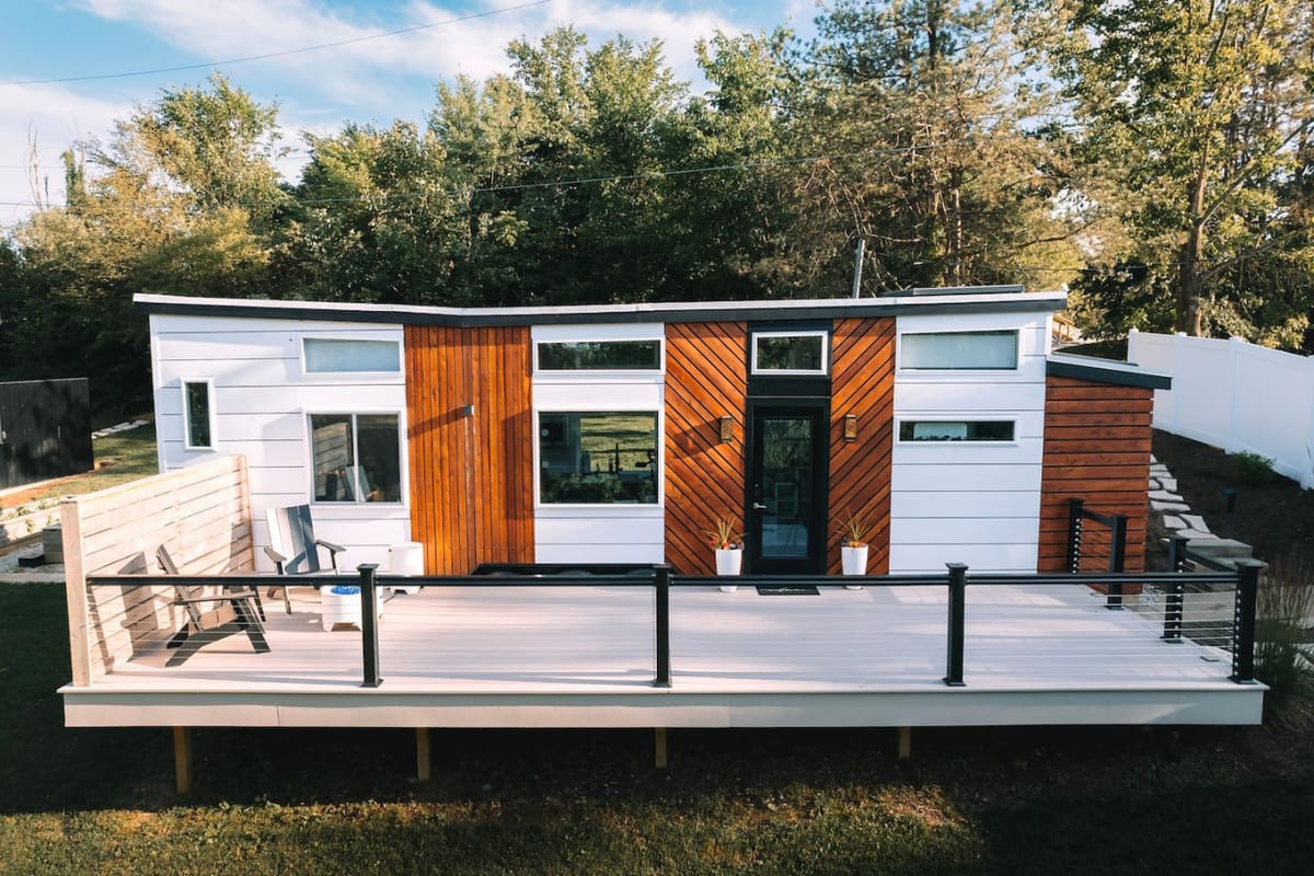 The Lux tiny home and its full-length deck on the Tiny Stays Berlin property