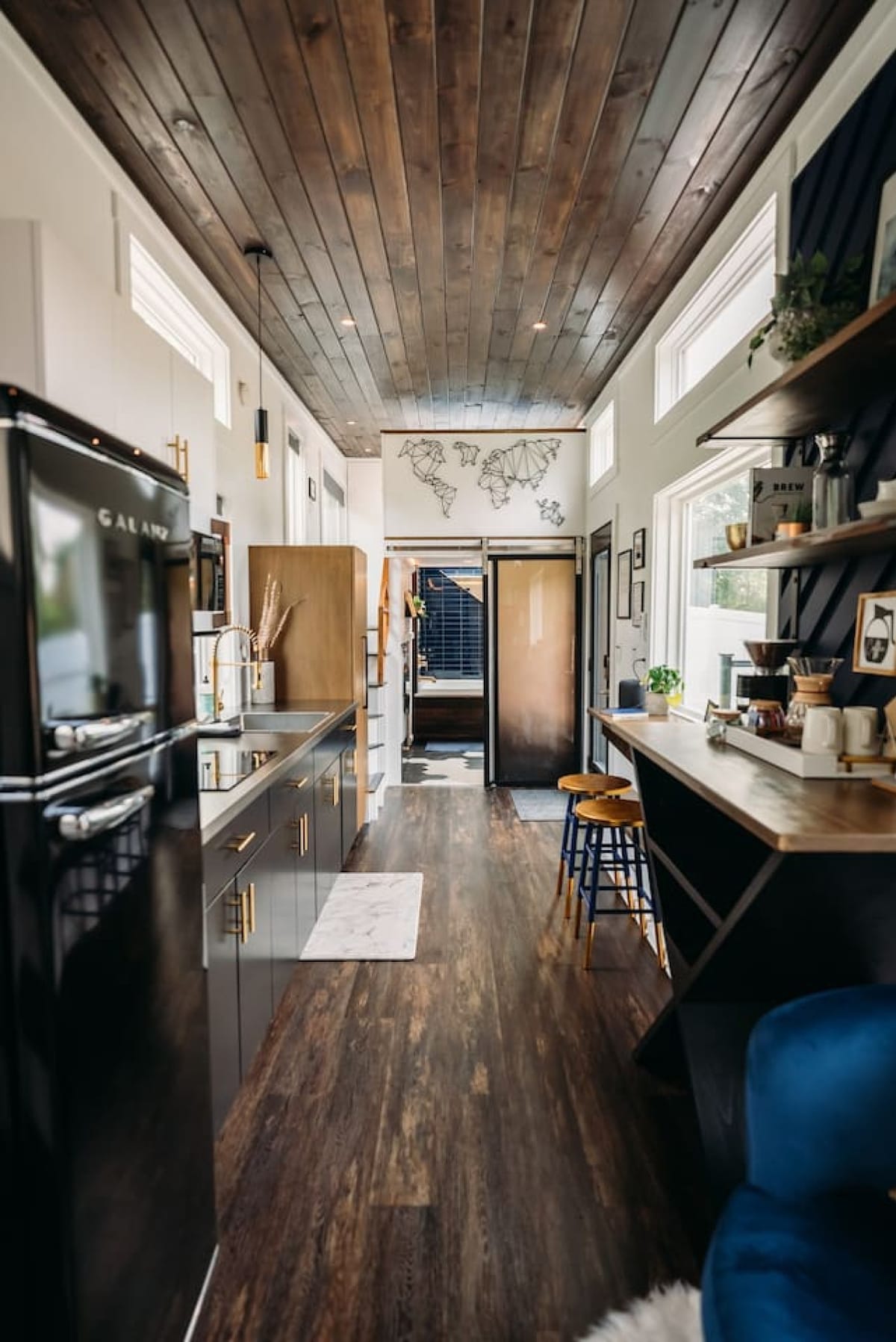 The Lux full kitchen with a black retro fridge and breakfast bar
