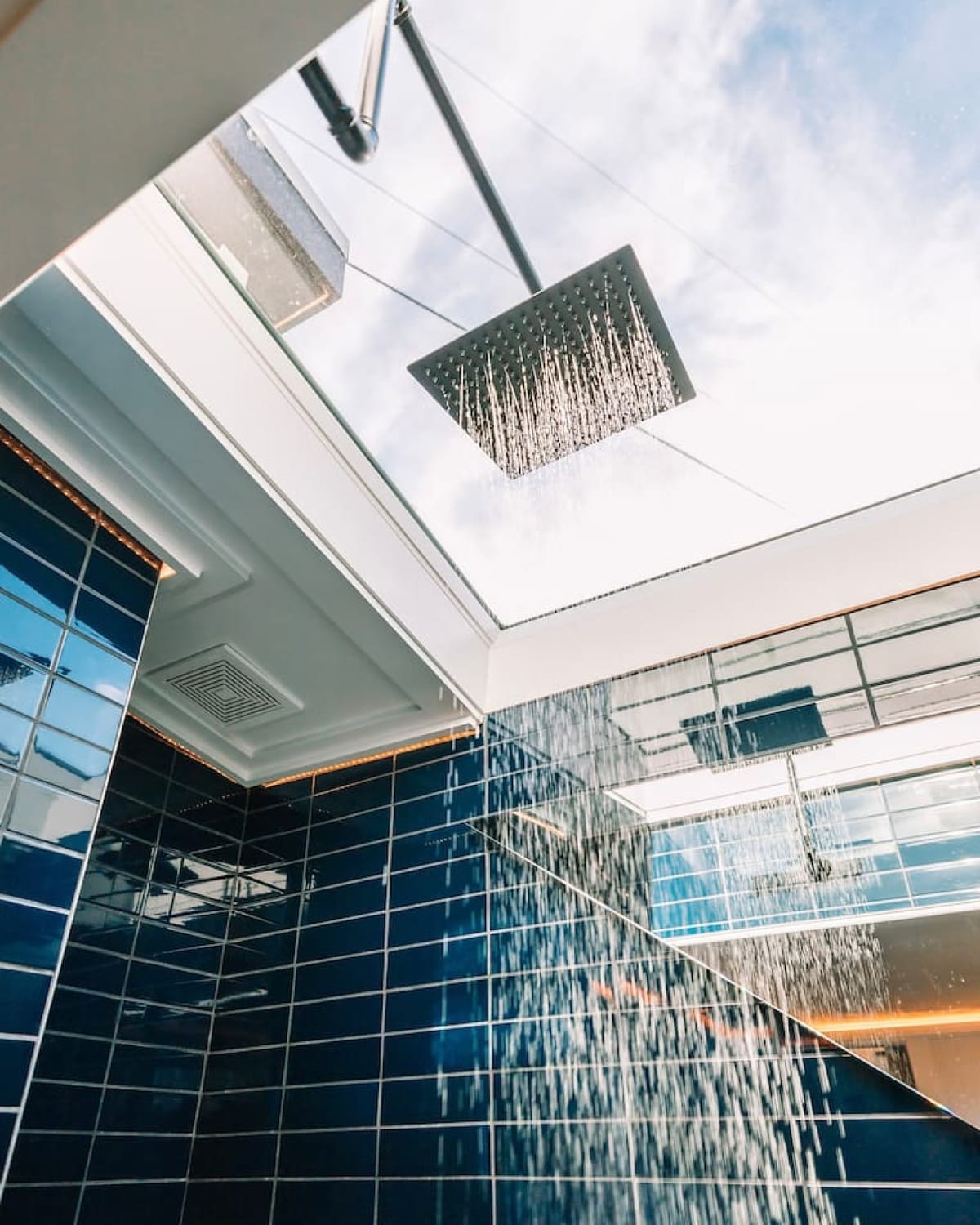 Rain shower beneath a large skylight in The Lux bathroom