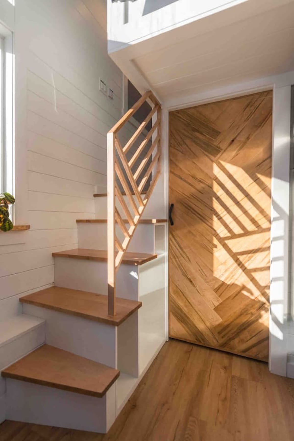 Oak stairs with a geometric railing inside The Scandi