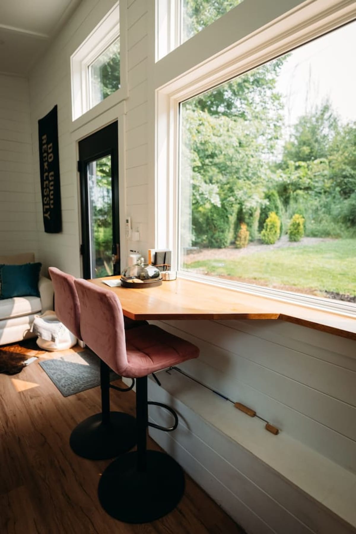 Window bar with a view of the trees inside The Scandi